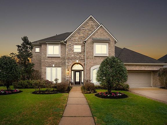 The amazing curb appeal will leave you wanting more! Beautiful neutral bricks are expertly accented by the stacked stone centered about the entrance. A double-wide driveway leads into a THREE car tandem garage w/ workbench & built-in cabinets!