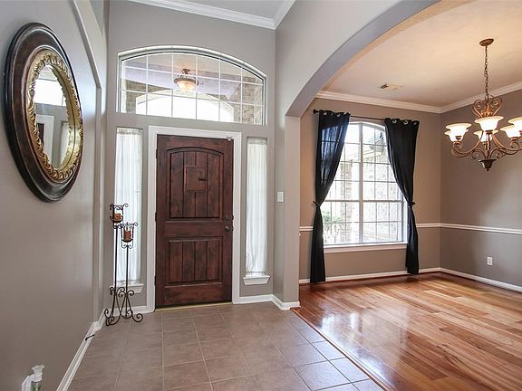 Spacious open and light, the formal dining room offers wood floors, crown molding and a chair rail.