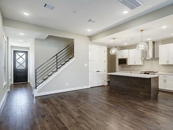 Gleaming hardwood floors great you upon entry and continue throughout the first floor open concept living.
