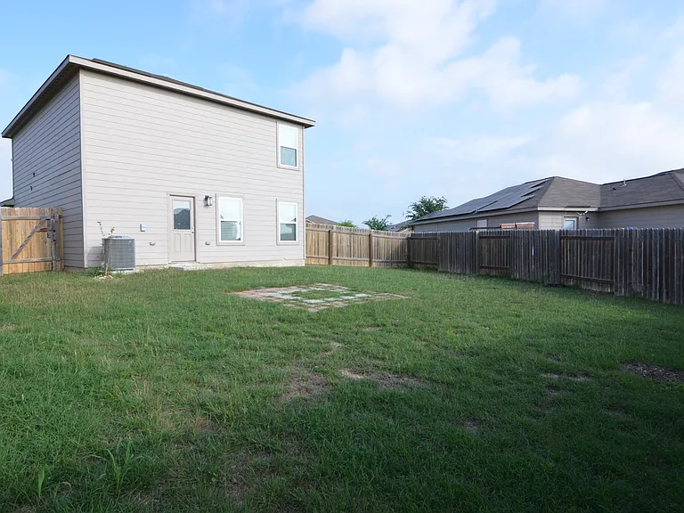Private fenced backyard with open space, ideal for outdoor use and relaxation.
