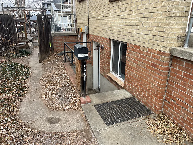 Front/South Side entry. There is an additional backyard entry in the background (elevated) to the unit that goes through the laundry/mechanical room