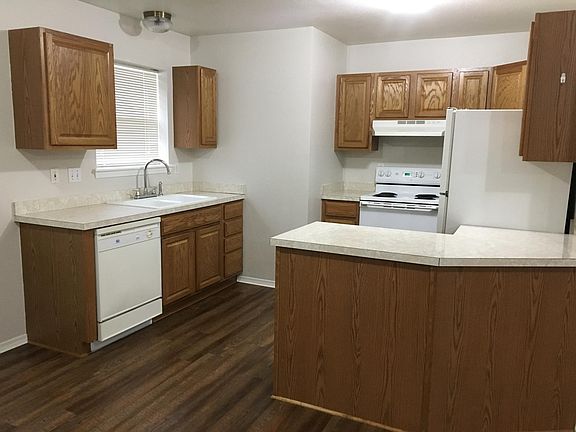 Well laid out kitchen with oven, range, dishwasher, and refrigerator/freezer.