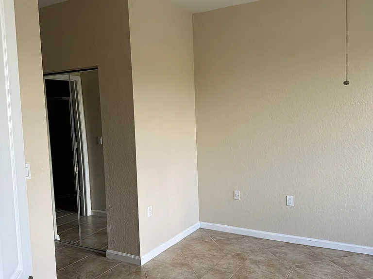 Entering the master bedroom you see the double mirrored walk-in closets off to the left.