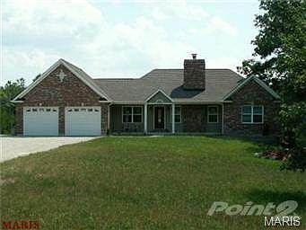 Brick and stone front atrium ranch. Covered porch, leaded glass