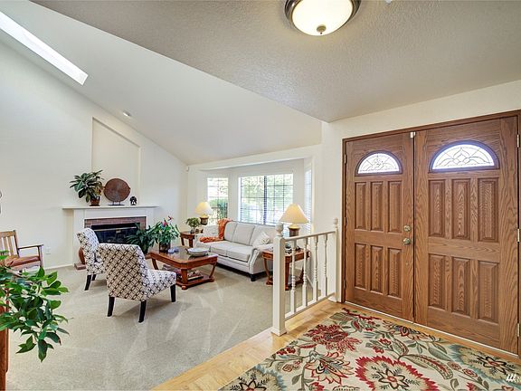 Wide entryway features hardwood floors and leads to the large sunken family room>