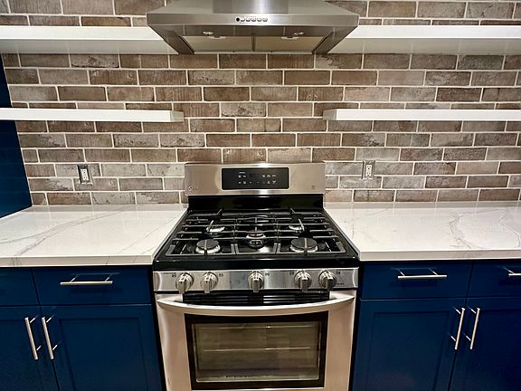 Gas range , new hood, open shelving