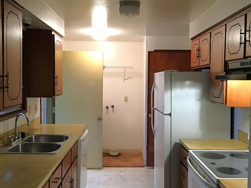 There is door directly go to your backyard in the kitchen. The refrigerator is about three years old. The stove is element type .