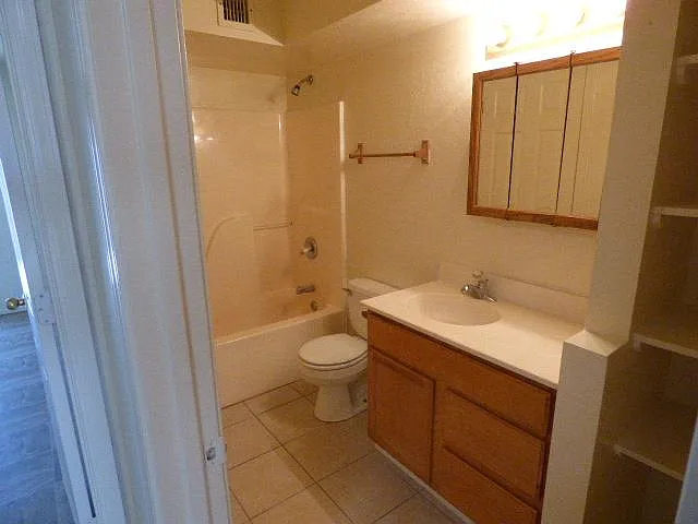 Bathroom with tub shower. Lots of storage