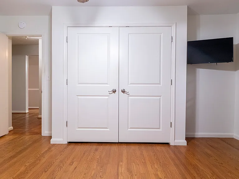 1st floor bedroom features a combined closet and laundry room.
