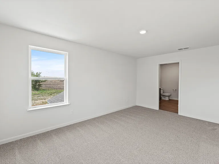 The master suite has a large bedroom, en-suite bathroom and spacious walk-in closet.