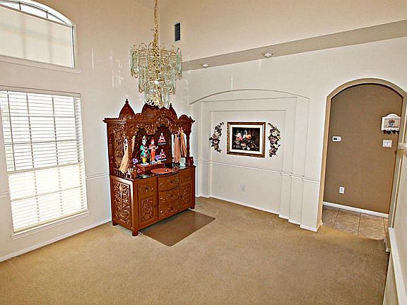 GRACIOUS ENTERTAINING WILL BE YOURS IN THE FORMAL DINING ROOM WITH ART NICHES AND CHAIR RAILING