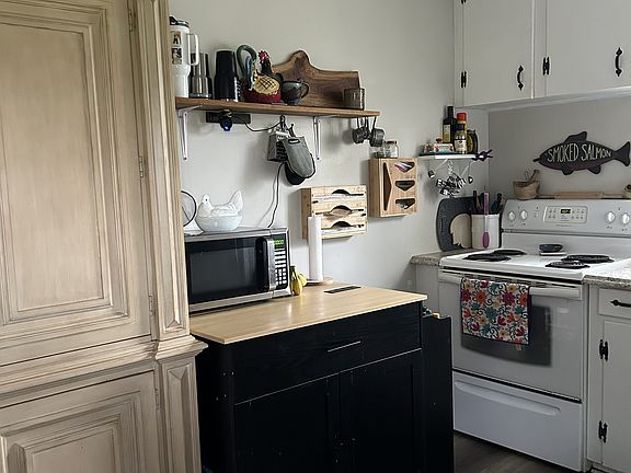 Microwave cart and microwave included along with large pantry