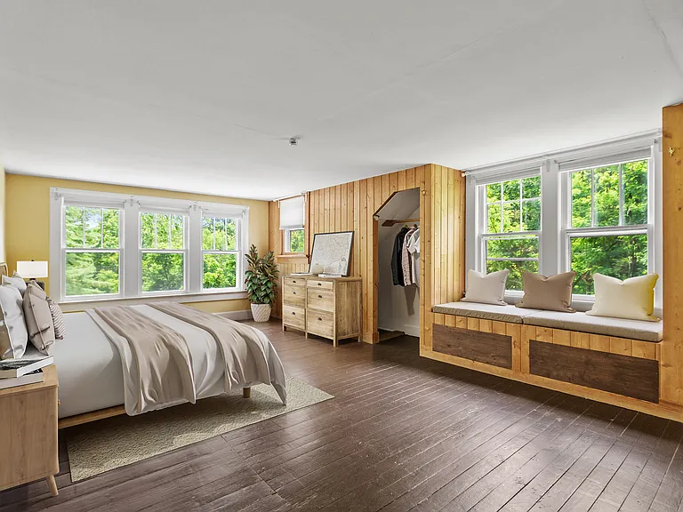 Upstairs master bedroom with window seat reading nook, 2 closets with original floors. This room is spacious, sunny and cheerful.