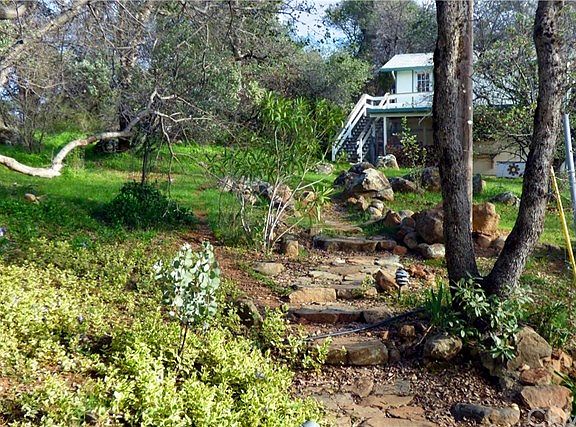 Native rock path leading to garage and bonus room/workshop above garage.