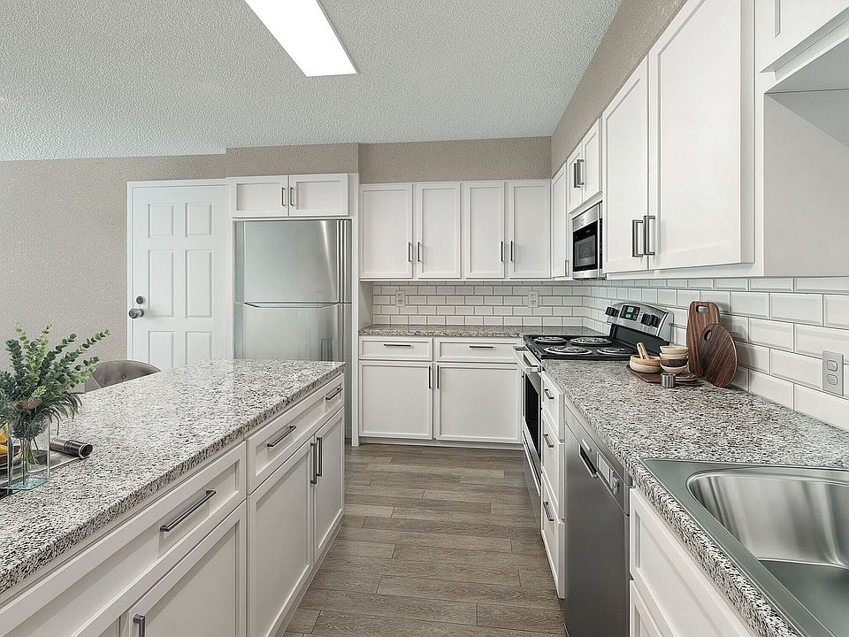 Kitchen with granite counters, stainless appliances, and modern cabinetry