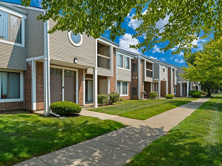 Private-Entry apartment buildings in Southfield with a walkway and sidewalk.