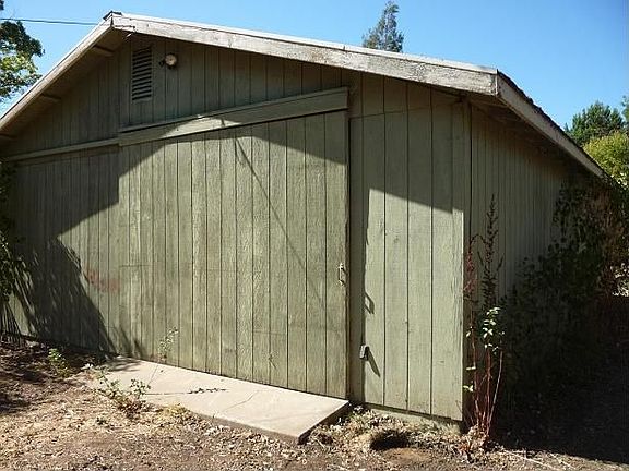 Four car garage with a drive through to the storage area and the 2 car garage
