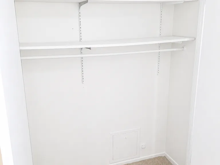 Extra interior storage space with shelving and hanging rod.