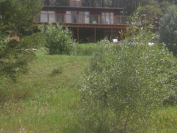 A view of the house on the hill above the road overlooking the water.