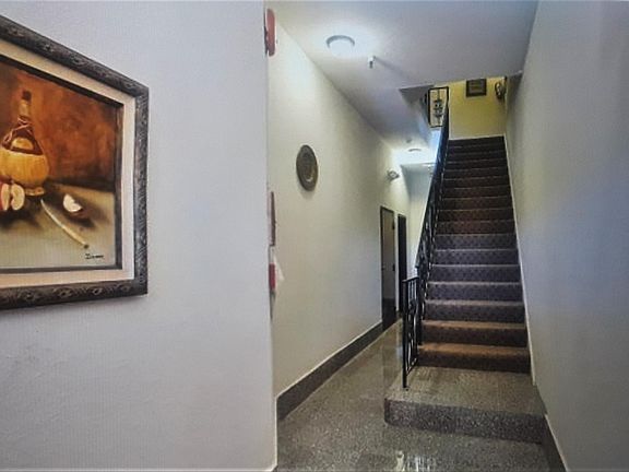 Lobby and Stairs Going Up to Unit