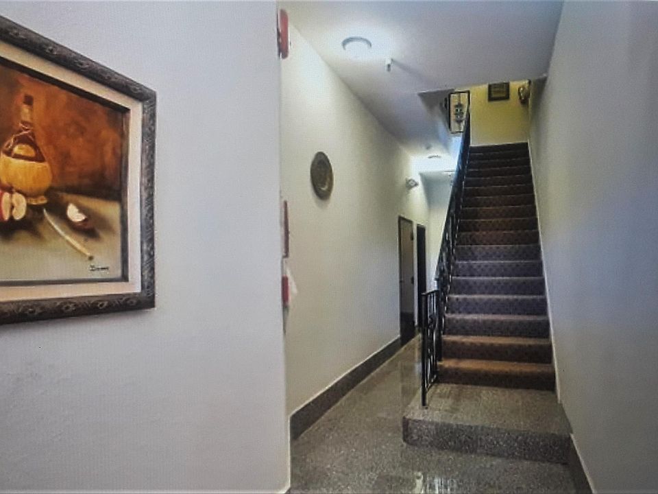 Lobby and Stairs Going Up to Unit