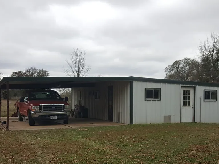 Extra storage building with second carport.