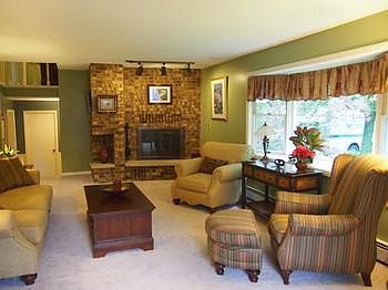 Gracious formal living room features one of two fireplaces.