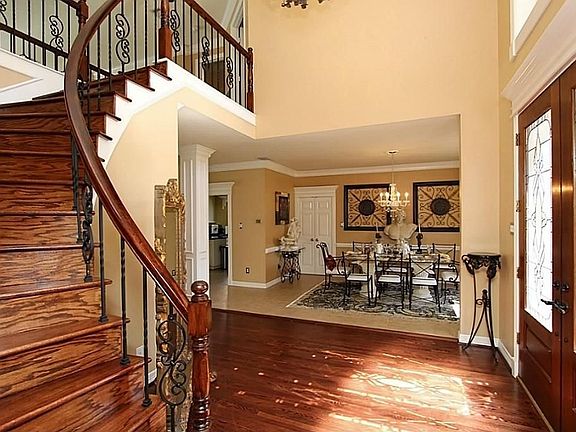 Rich wood flooring flows freely through this home.  The owners also added iron railings for a more luxurious/updated feel.