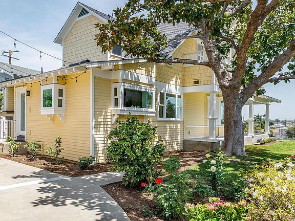 Old growth magnolia tree adds shade to this lovely double lot with generous side yard lawn and rear patio space for outdoor relaxing and entertaining.