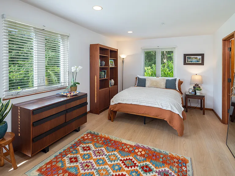 beautifully furnished bedroom with new queen bed, luxury sheets and Turkish Kilim
