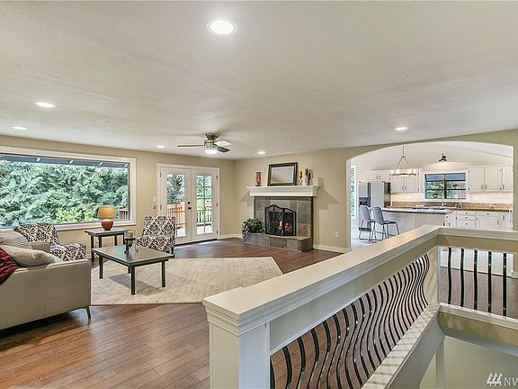 As you enter the home you are drawn to the welcoming family room and spacious kitchen. These spaces are wonderful for entertaining. The expansive windows and glass French doors give you the feeling that you're up in the trees - and yet the home is light and bright!