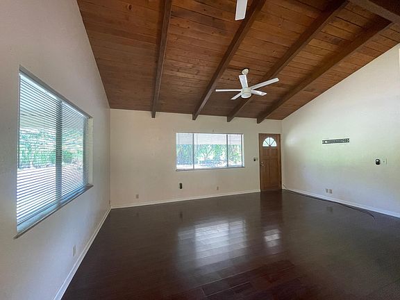 Living room with brand new blinds and fans