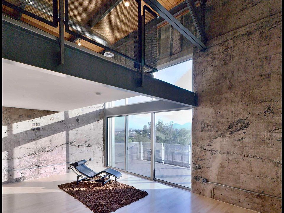 Living room, loft bedroom (above) and balcony