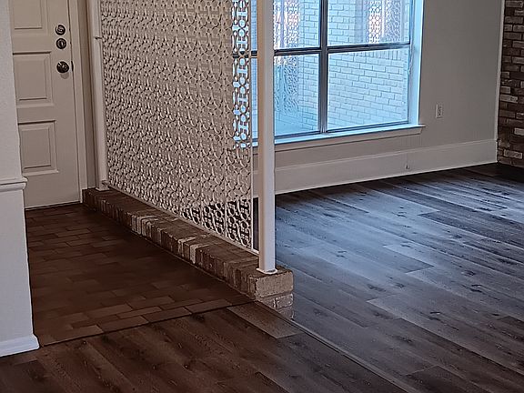 Front door, entryway and west windows in living room