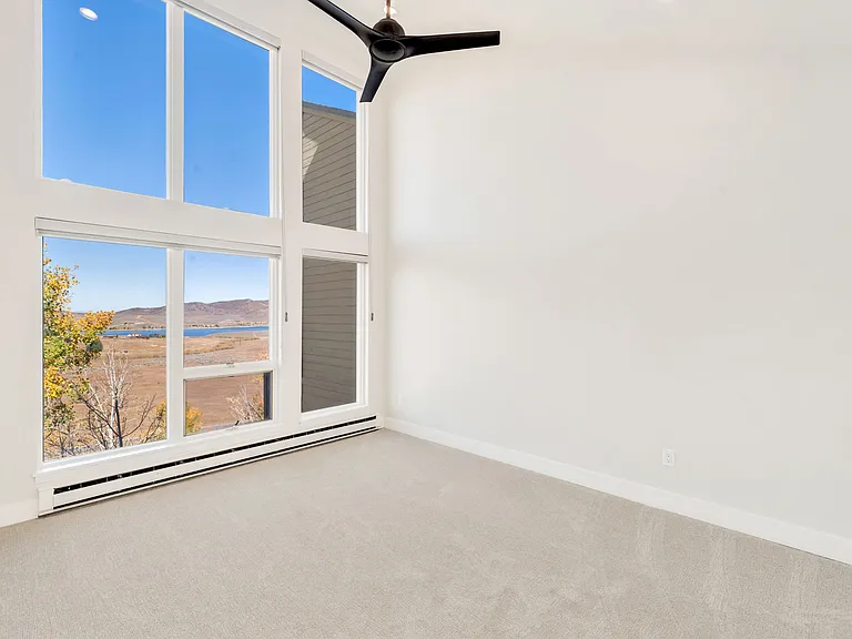 Bedroom #3 - on upper level. Floor to ceiling windows with electric black out window shades.