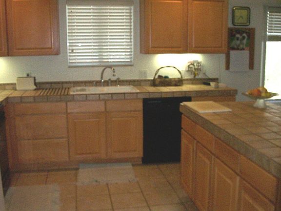 Honey maple cabinets and rustic tile counters offer casual elegance.