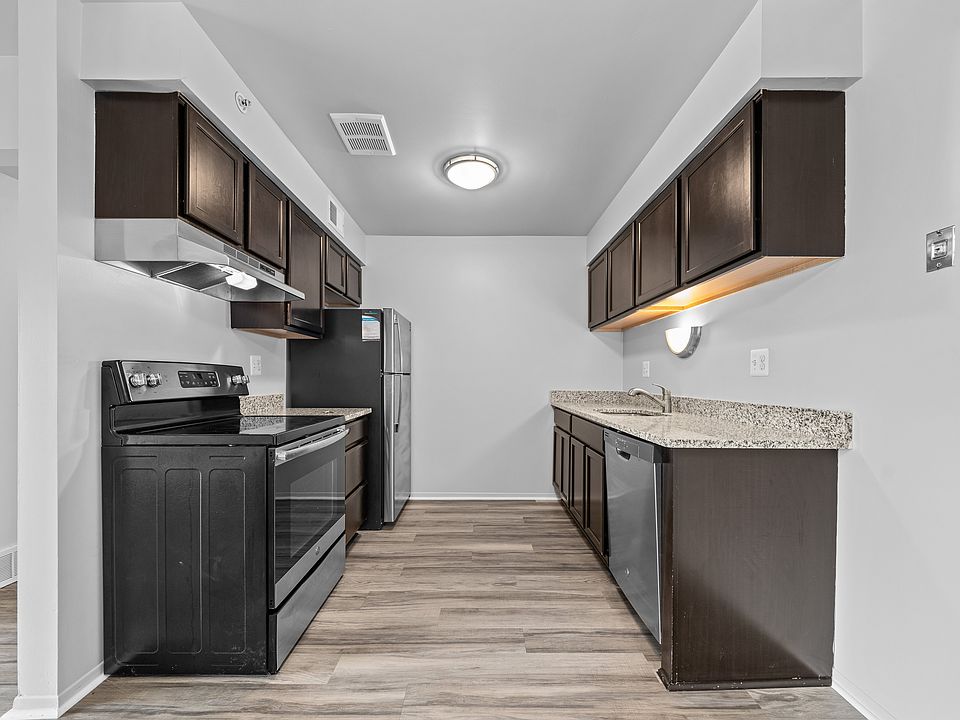 Upgraded Kitchen with stainless steel appliances and granite countertops at Westwood Village Apartments in Westland, MI