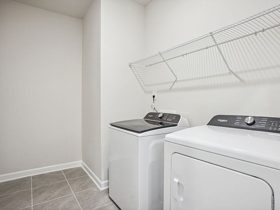 Laundry day is a breeze with space and shelving for organizing and folding clothes.