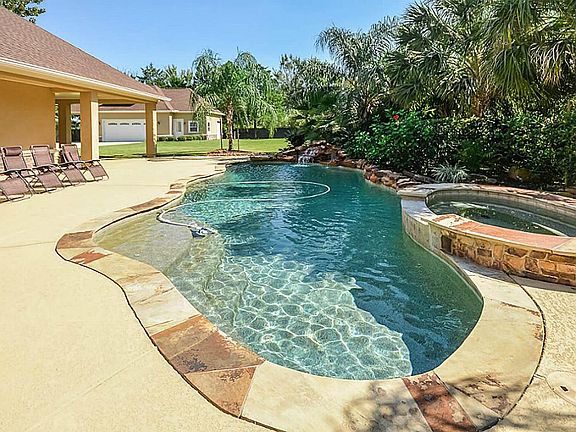 Enjoy time out here in the salt water pool with a waterfall, light features and a hot tub. There is lots of outdoor lighting to enjoy evenings around the pool.