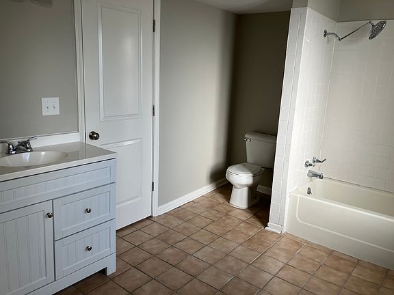 Large bathroom w/ adjacent laundry room ( not shown) w/ washer dryer hookup, and additional shelving & place to hang clothes
