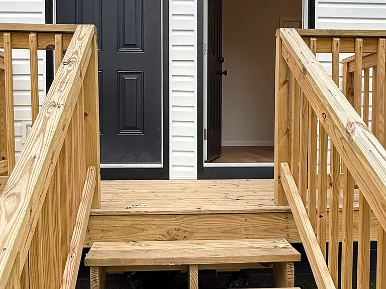 Large fenced backyard with an expansive lawn and plenty of room for outdoor activities, relaxing, gardening, or entertaining. Private rear entrance with a dedicated wooden deck and steps provides convenient access to the backyard.