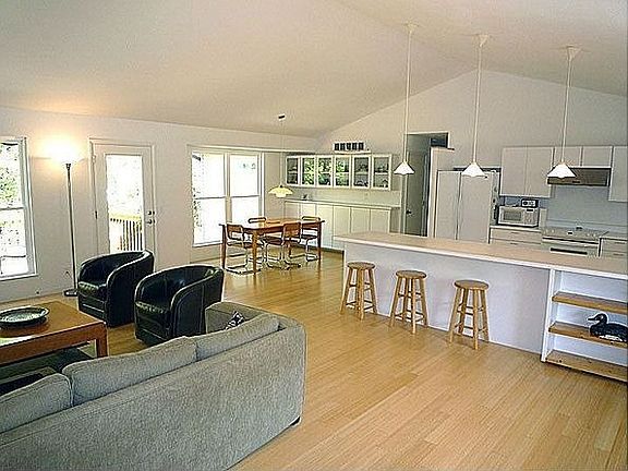 great room with vaulted ceiling and bamboo floors