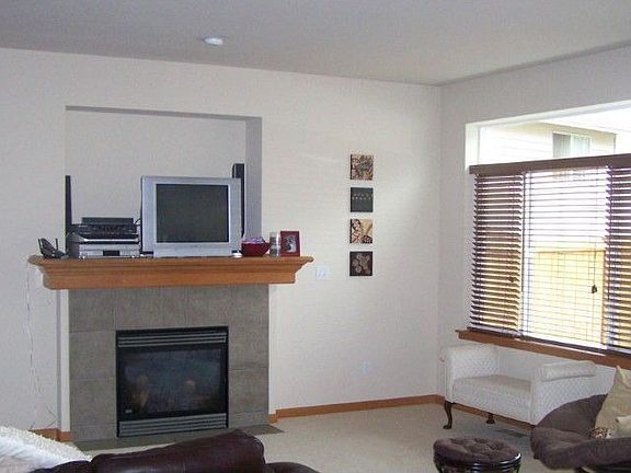 Open spacious family room w/ tile surround gas fireplace & recessed wall for big screen; room will a