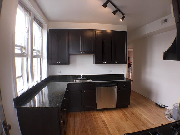 SHARP ESPRESSO CABINETS, GRANITE COUNTERS AND STAINLESS STEEL APPLIANCES