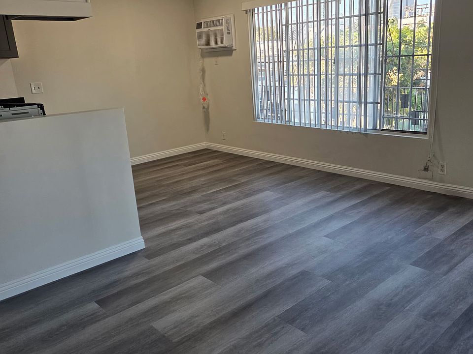 living room with huge window bringing in natural lighting. new 2 in 1 AC heater unit