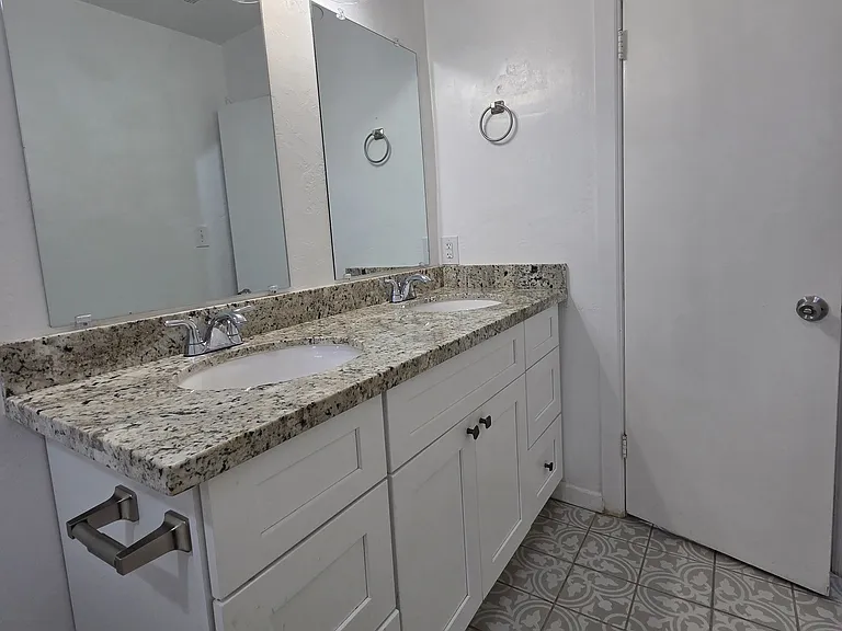 Double sink full bathroom with tub/shower. Beautiful tile floors and granite countertop.