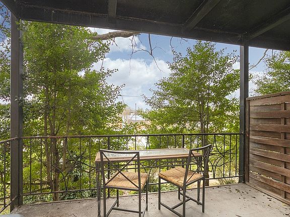 spacious porch - overlooks part of McCabe park's parking lot, with views of golf course and greenway. Pleasantly covered with trees for privacy.