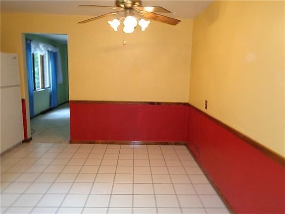 Area for large table in the Eat in Kitchen, ceiling fan, ceramic tile floor.