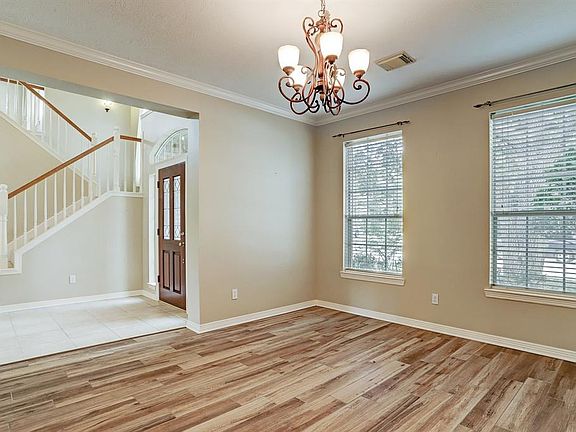 Enjoy the spacious formal dining room open to two-story foyer. Wood blinds, moldings and wood look tile flooring. Great for celebrating those special holidays.