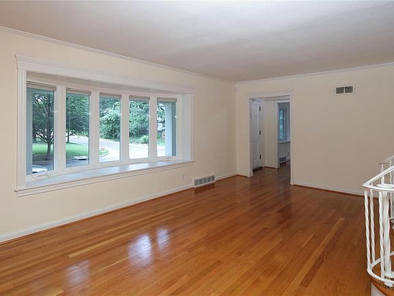 Entry opens to an inviting living room with curved bay windo